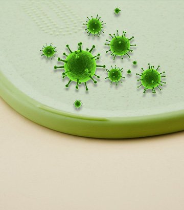 Cutting board surface shown with stylized green virus or bacteria illustrations