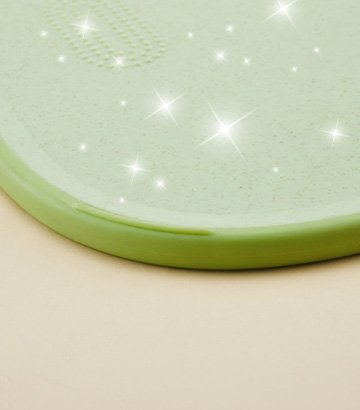 Pristine green cutting board surface sparkling clean with white star sparkles